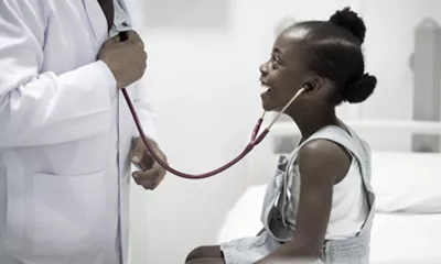 a young child with a stethoscope on her neck