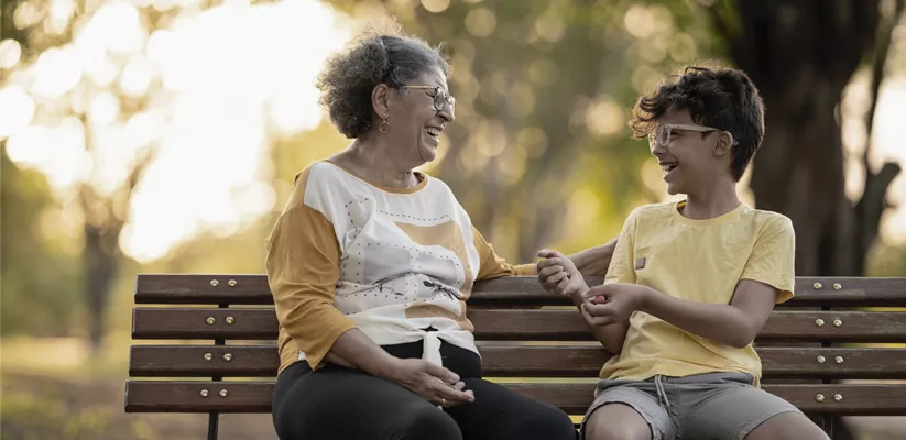grandmother and child sitting on a bench